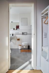 a white bathroom with a toilet and a sink at Urlauberei Malchow in Malchow