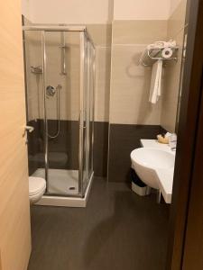 a bathroom with a shower and a toilet and a sink at Hotel Spazio Residenza in Pescara