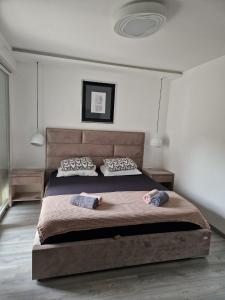 a bedroom with a large bed with two pillows at Apartment ILLARIA in Rijeka