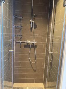 a shower with a hose in a bathroom at Lin et l'autre appartement in Limmen