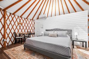a bedroom with a bed and a table in a tent at OT 3515E Texas Yurt Haus 5 Yurts in New Braunfels +27 photos