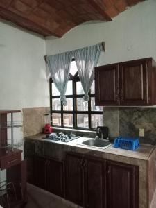 a kitchen with a sink and a window at HOTEL Y VILLAS CASA AZUL in Rincon de Guayabitos