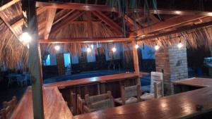 a large wooden room with a wooden table and chairs at HOTEL Y VILLAS CASA AZUL in Rincon de Guayabitos