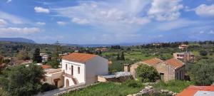 a view of a village with buildings and trees at Giannis Traditional House in Vamos