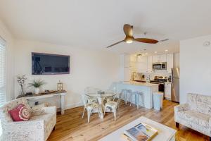 a living room with a table and a kitchen at Grand Caribbean East & West, E212 in Perdido Key