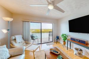 a living room with a flat screen tv and a couch at A Dreamer's Cottage in Clearwater Beach