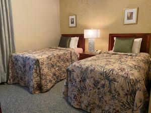 a hotel room with two beds and a phone at Kingston Hotel in Vancouver