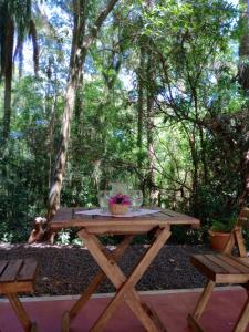 a picnic table in the middle of a forest at Yurtas Ivirareta Glamping in Garupá