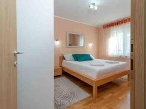 a bedroom with a bed in a room at Cozy House in Seget Vranjica