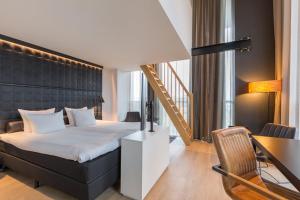 a hotel room with a bed and a staircase at Leonardo Hotel Groningen in Groningen