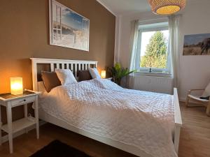 a bedroom with a white bed and a window at Dream Living 1 im Essener Süden in Essen