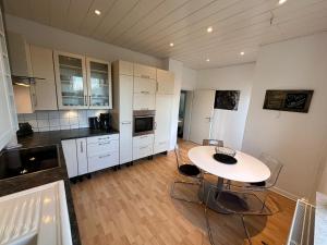 a large kitchen with a table and chairs in it at Dream Living 1 im Essener Süden in Essen
