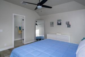 a bedroom with a blue bed and a ceiling fan at Palagi Place in Austin +18 photos