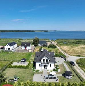 an aerial view of a house with the water at Villa Bella Zastan Sauna & Jacuzzi in Międzywodzie