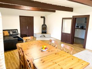 comedor y sala de estar con mesa de madera en Chalupa Rozálka en Cerny Dul