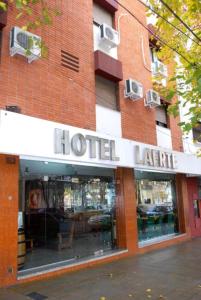 a hoteliane sign in front of a brick building at Laerte Hotel Mendoza in Mendoza