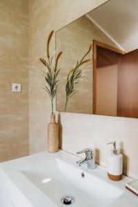 a bathroom with a sink and a mirror at Forno House - O Lagar in Vila Praia de Âncora