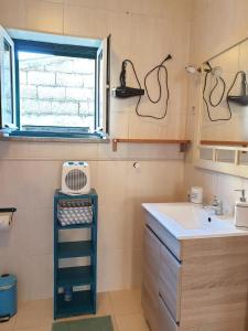 a small bathroom with a sink and a window at Casa na Serra 2, Sabugueiro in Sabugueiro