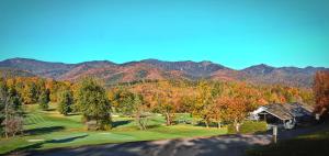 an aerial view of a golf course with mountains in the background at Mt Mitchell Cabin Rentals in Busick