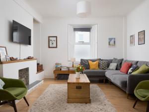 a living room with a couch and a table at Saltwater Cottage in Torquay