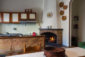 a kitchen with a brick fireplace in a kitchen at Casa di nonna in Bevagna
