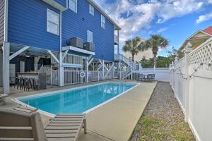 - une piscine en face d'une maison bleue dans l'établissement Large Home with Hot Tub and Pool 500 ft to the Beach, à Myrtle Beach