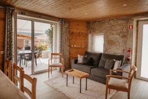 a living room with a couch and a table at Forno House - O Lagar in Vila Praia de Âncora