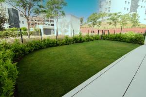 A garden outside Mara's Apartments Higueron West - Like A House - 246 Square Meters of Private Terrace & Garden - Morning and Evening Sun