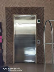 a metal elevator door in a building at Savoy Express in Torreón