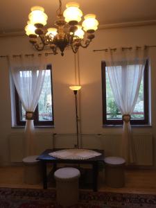 a dining room with a table and two windows at Apartment Dedo in Koper