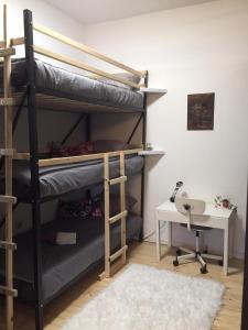a room with bunk beds and a desk and a table at Apartment Dedo in Koper