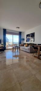 a living room with a couch and a table at Esmeralda Suites Sunrise in Calpe