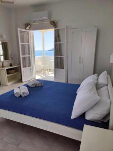 a bedroom with a bed with two towels on it at Kleanthi Apartments in Drios