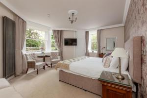a bedroom with a bed and a desk and a chair at Victoria Square & The Orangery in Stirling
