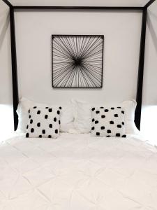 a bedroom with a bed with black and white pillows at The Idyll Boutique Apartment - Spanish Quarter in Naples