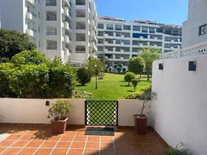 a balcony with a fence and a lawn with buildings at Puerto Banus in Marbella