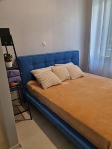 a blue bed with two pillows on top of it at City Life Metro Ambelokipi in Athens