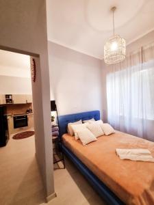 a bedroom with a large bed with a blue headboard at City Life Metro Ambelokipi in Athens