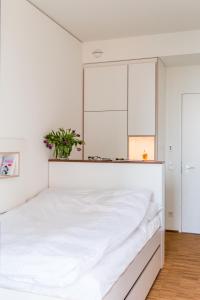 a bedroom with a white bed with a plant on it at Seminarhaus S1516 in Berlin +28 photos