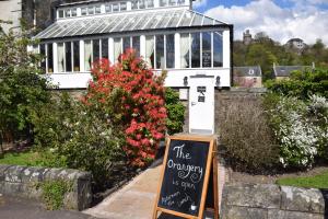 a house with a chalkboard sign in front of it at Victoria Square & The Orangery in Stirling