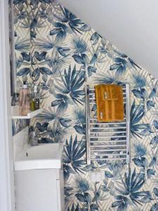 a bathroom with a blue and white wall at Blackberry Loft - a Hidden Gem in Templepatrick