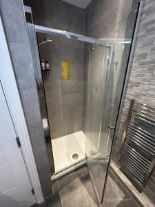 a shower with a glass door in a bathroom at Entire 2 bedroom apartment! in Whetstone