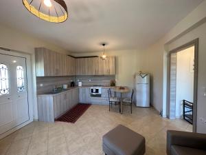 a large kitchen with a table and a refrigerator at Georgia's Guesthouse in Kalabaka