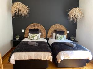 two beds sitting next to each other in a bedroom at Boma choma in Beaufort West