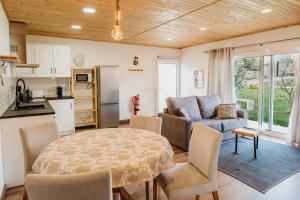 a kitchen and living room with a table and a couch at Forno House - Ameixoeira in Vila Praia de Âncora