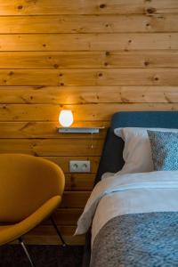 a bedroom with a bed and a yellow chair at New Gudauri Atrium in Gudauri