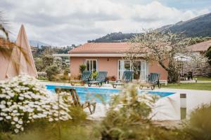a house with a swimming pool in front of a house at Forno House - Ameixoeira in Vila Praia de Âncora