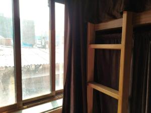 a bedroom with a bunk bed next to a window at Super Champions Hostel in Mumbai