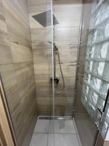 a bathroom with a shower with a glass door at Klify Jastrzębie Premium in Jastrzębia Góra +38 photos