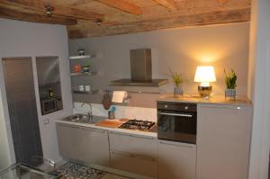 a kitchen with a stove top oven next to a sink at La contrada in Cuneo